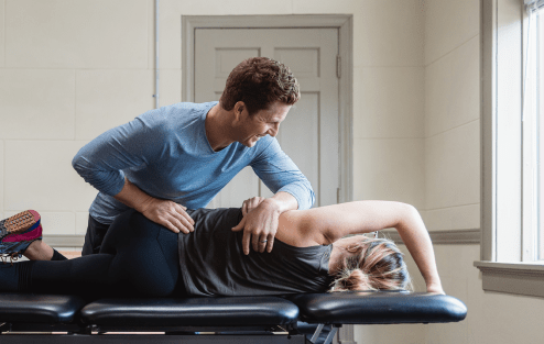 Physical Therapist with patient assisting with massage