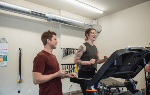 Physical Therapist with patient helping train cardio